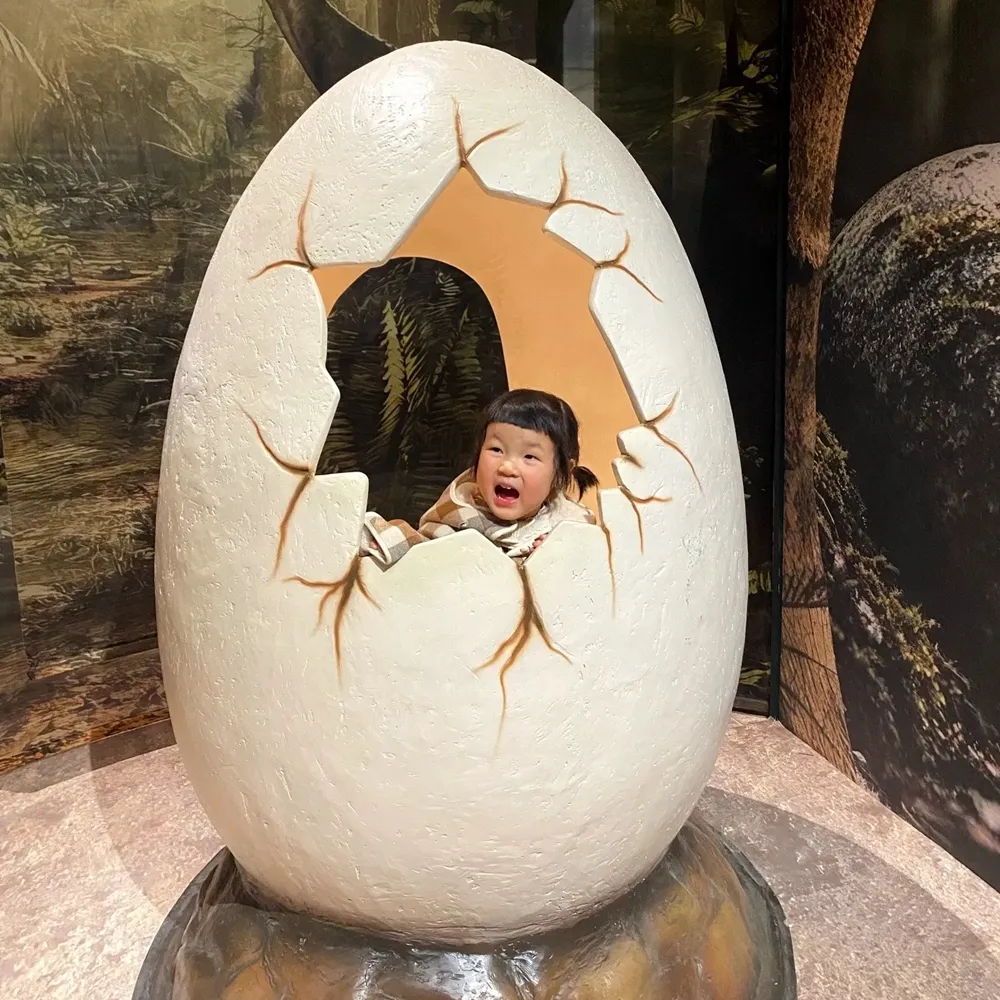 Kids taking photos with dinosaur eggs